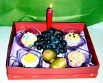 CSG11 Cupcakes in a box with a candle and grapes.